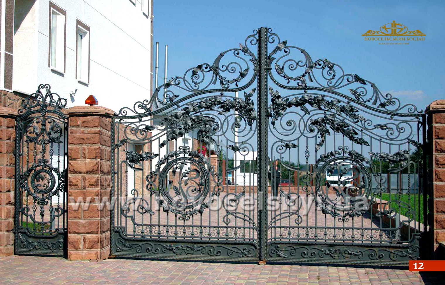 Open forged gate with forged leaves